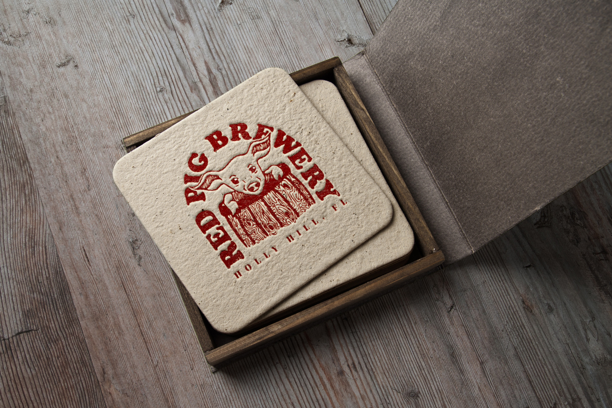 nice coasters with red pig brewery logo
